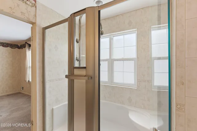 a bathroom with a glass shower door