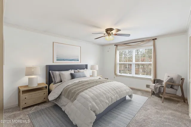 a spacious bedroom with a bed and a chandelier