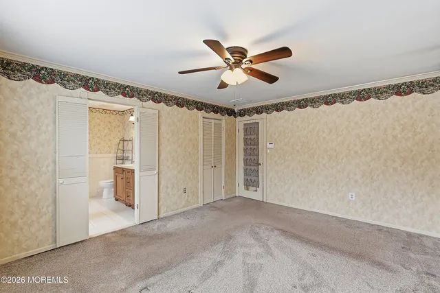 a view of a livingroom with a ceiling fan and window
