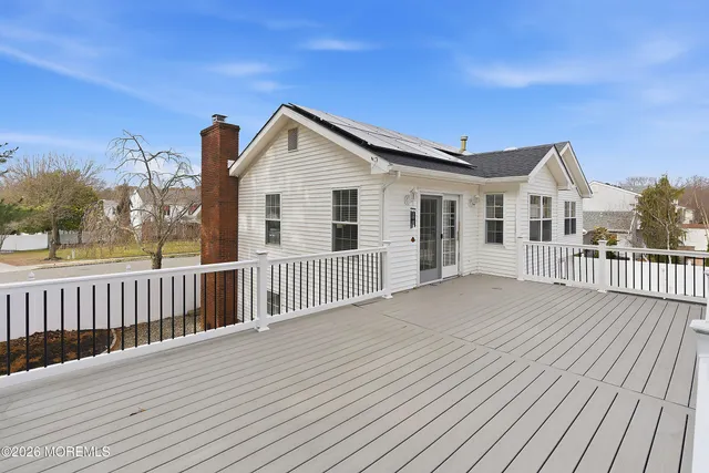 a view of a house with wooden deck