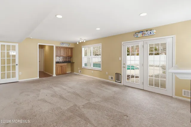 a view of an empty room with a fireplace and a window
