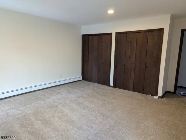 a view of an empty room with wooden walls