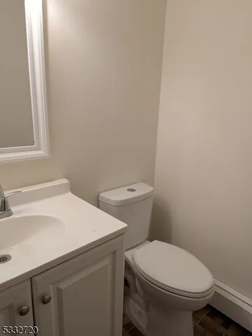 a white toilet sitting next to a white sink
