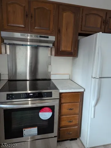 a stove top oven sitting inside of a kitchen