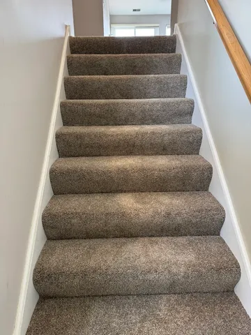 a view of staircase with white walls