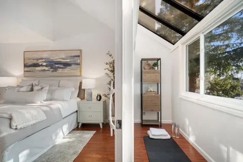 a bedroom with a bed and a painting on the wall