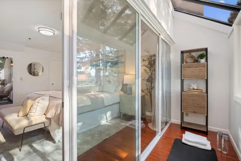 a bathroom with a glass shower door and a glass door