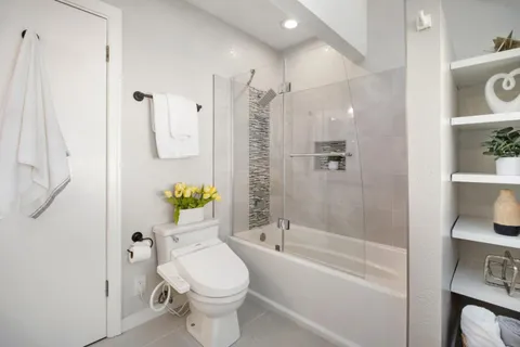 a bathroom with a toilet and shower