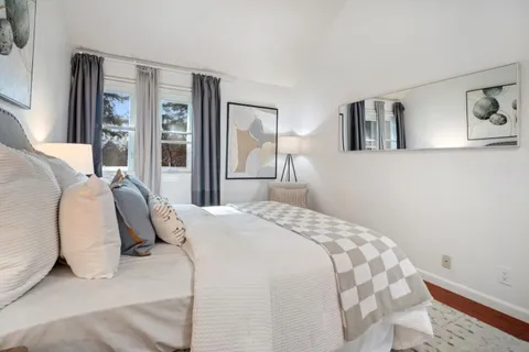 a bedroom with a large bed and a window