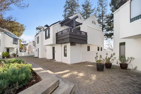 a view of a street with potted plants