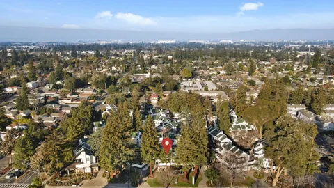 an aerial view of residential houses with city view
