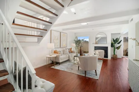 a living room with fireplace furniture and a wooden floor