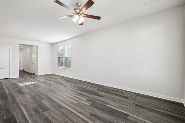 a view of a kitchen with furniture and wooden floor
