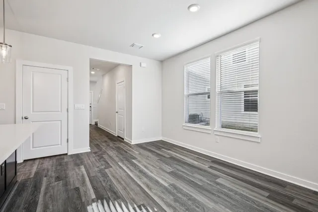 a view of kitchen with granite countertop cabinets and wooden floor