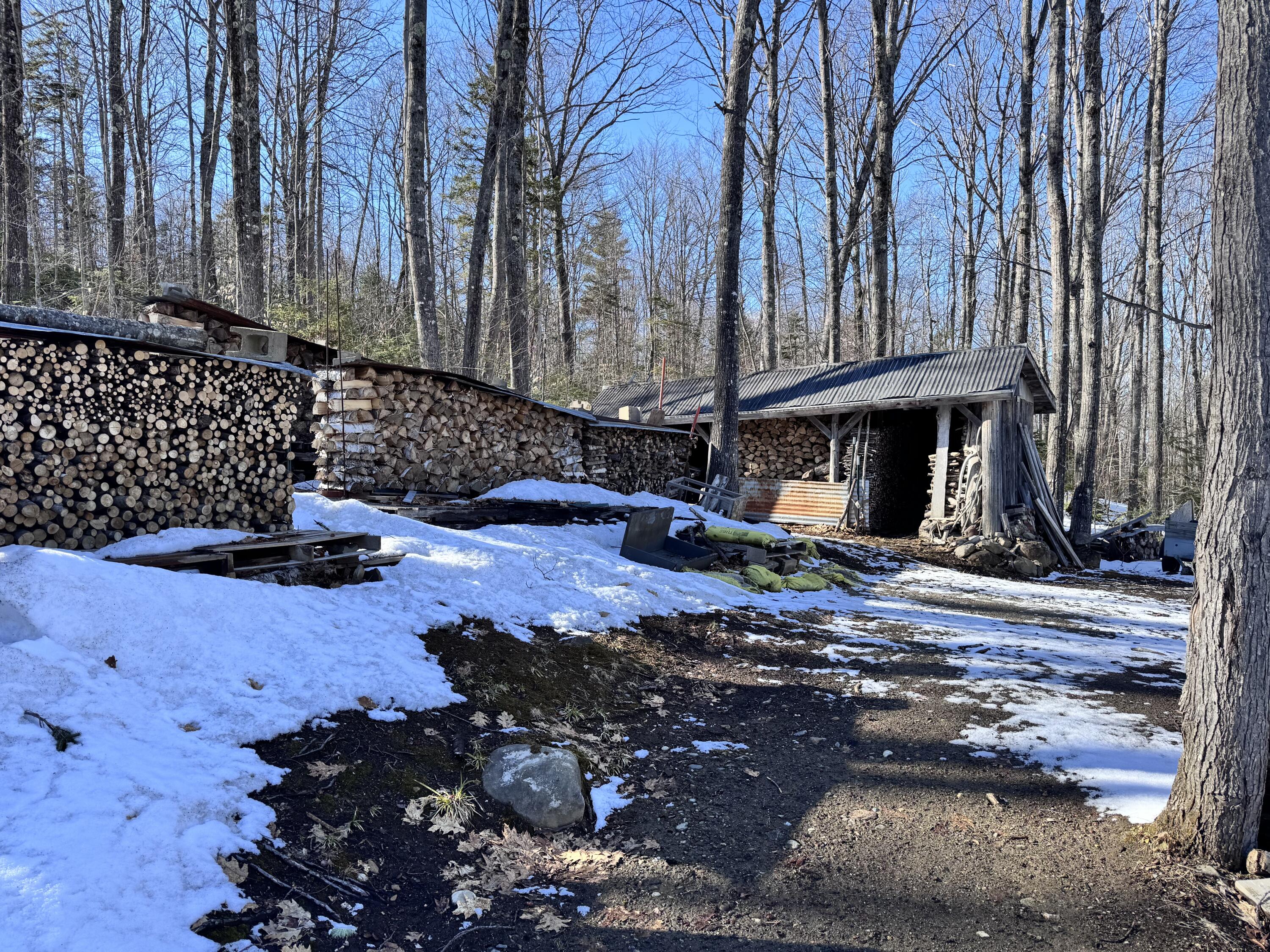 262 Mitchell Brook Road Temple, ME 04984 - Photo 31 of 65 Stacked wood
