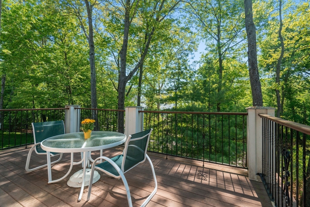 287 Langley Road, Unit 43 Newton, MA 02459 - Photo 14 of 36 a patio with yard glass top table and chairs