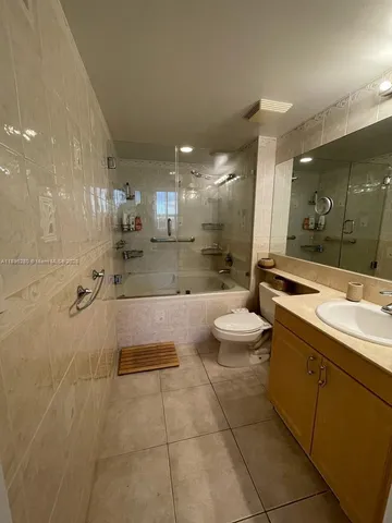 a bathroom with a double vanity sink toilet and a mirror