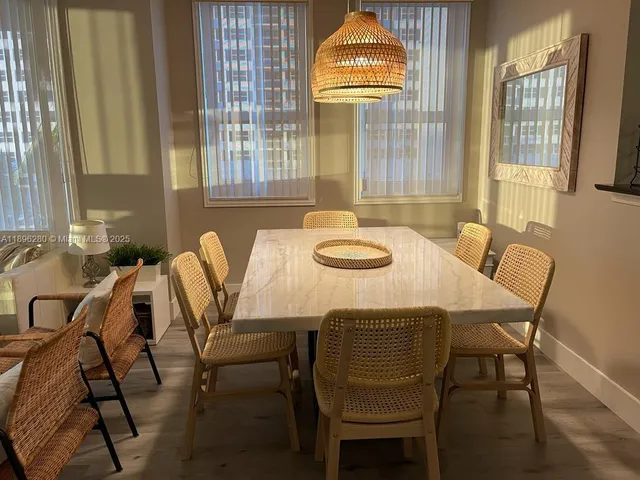 a view of a dining room with furniture and a window