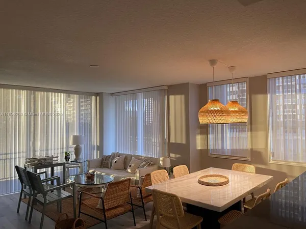 a view of a dining room with furniture and window