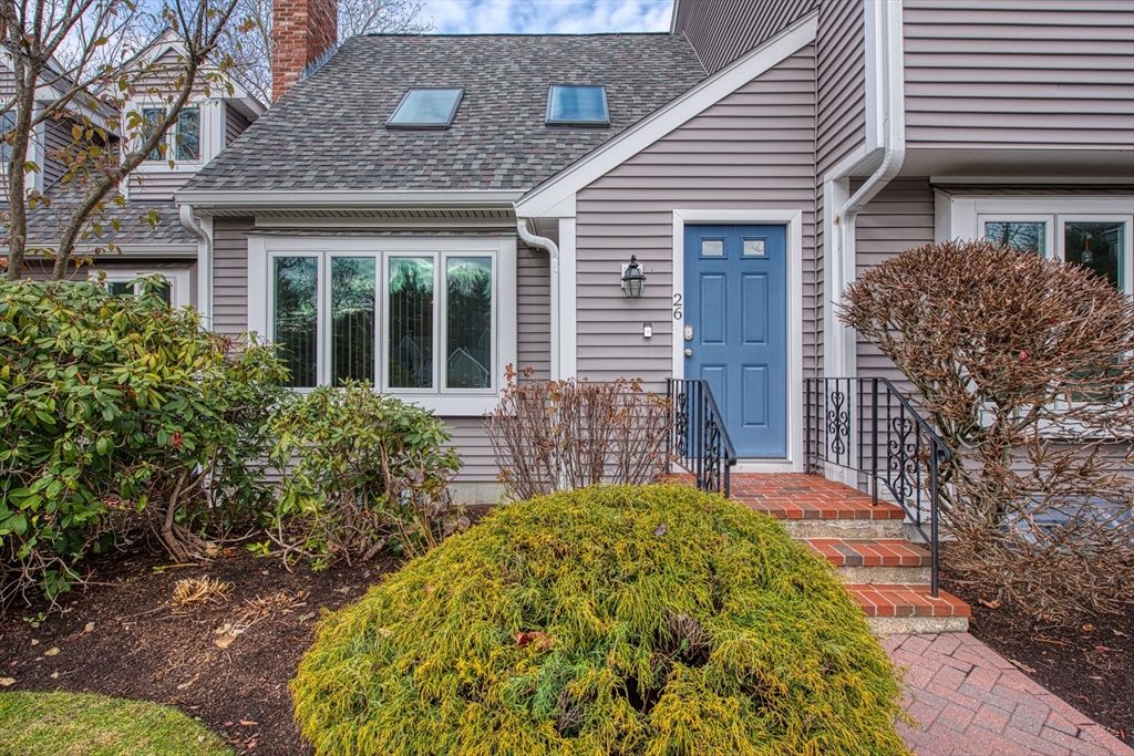 a front view of a house with a garden