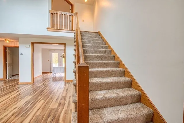 a view of entryway and hall with wooden floor