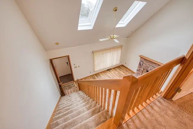 a view of a bedroom with wooden floor and stairs