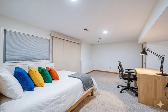 a bedroom with a bed and a desk
