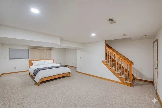 a spacious bedroom with a bed and a window