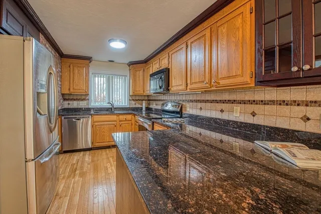 a kitchen with wooden cabinets and stainless steel appliances