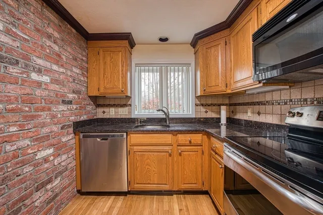 a kitchen with granite countertop a sink and cabinets