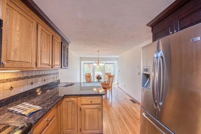 a kitchen with granite countertop a refrigerator and a sink