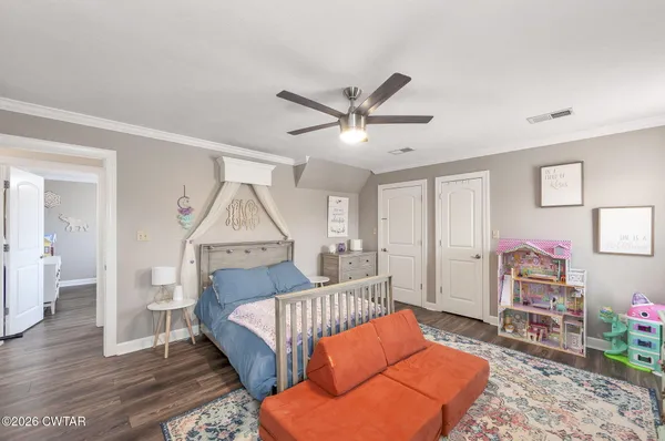 a living room with furniture a rug and a wooden floor