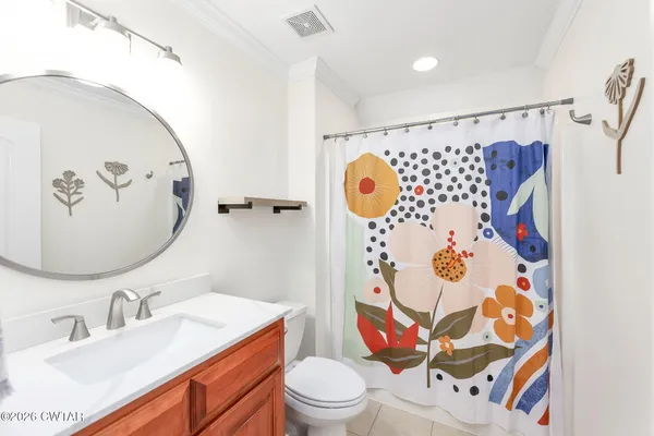 a bathroom with a sink mirror vanity and toilet