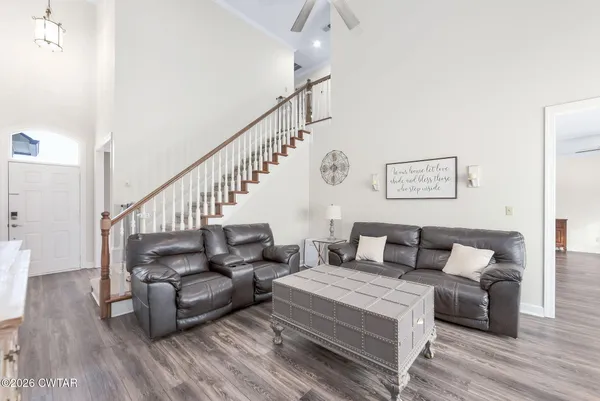 a living room with furniture and wooden floor