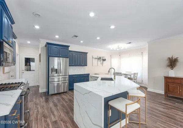 a kitchen with refrigerator and cabinets