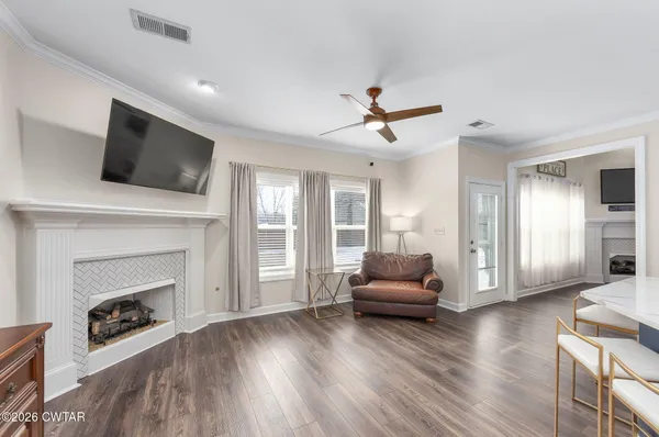 a living room with furniture and a fireplace