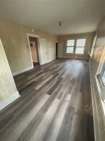 a view of wooden floor and windows in a room
