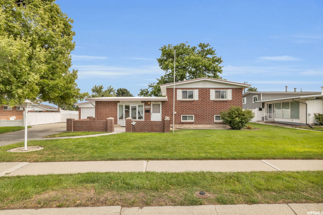 Split level home featuring a front lawn
