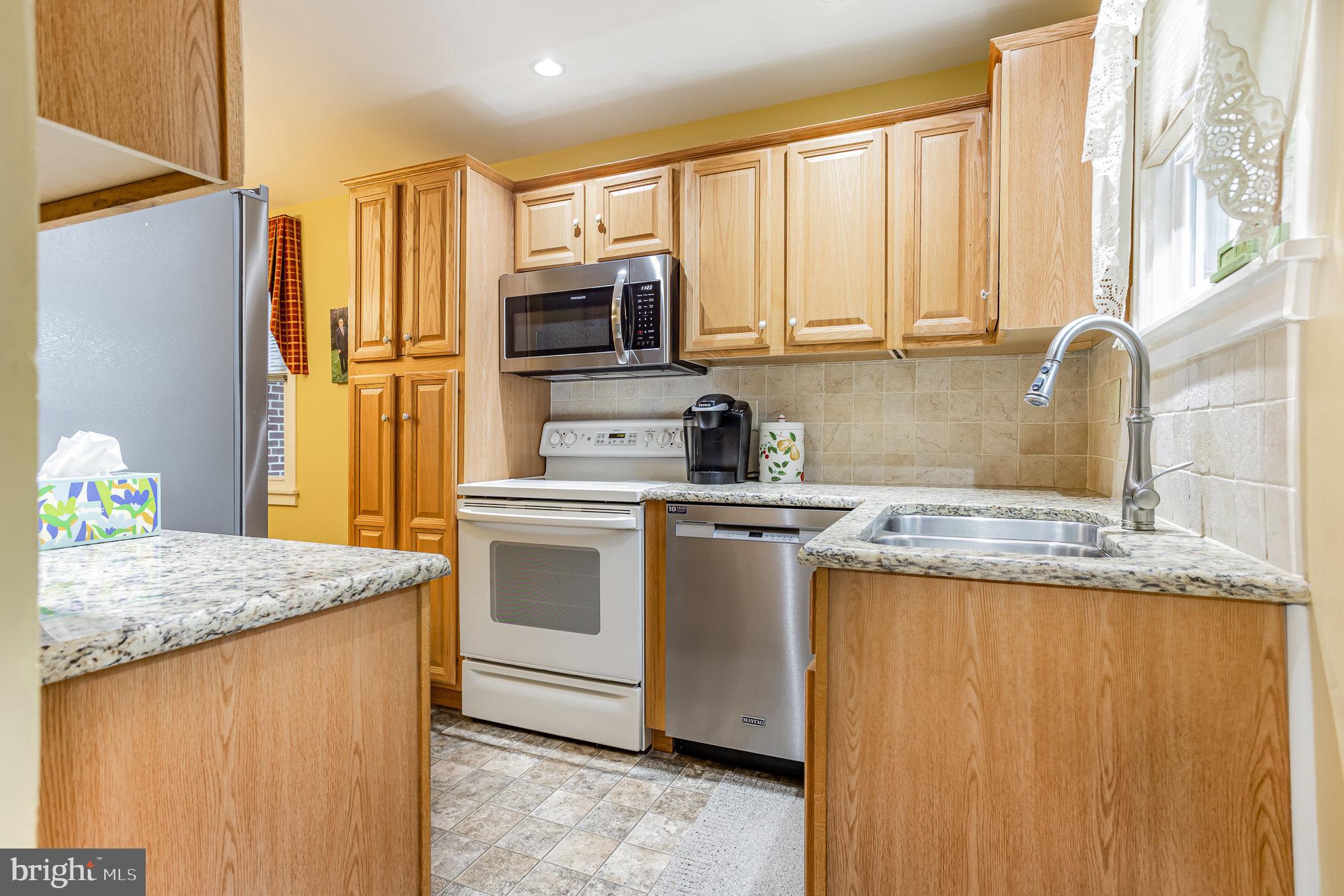 29 Maple Avenue Hershey, PA 17033 - Photo 13 of 32 a kitchen with stainless steel appliances granite countertop a sink stove and refrigerator