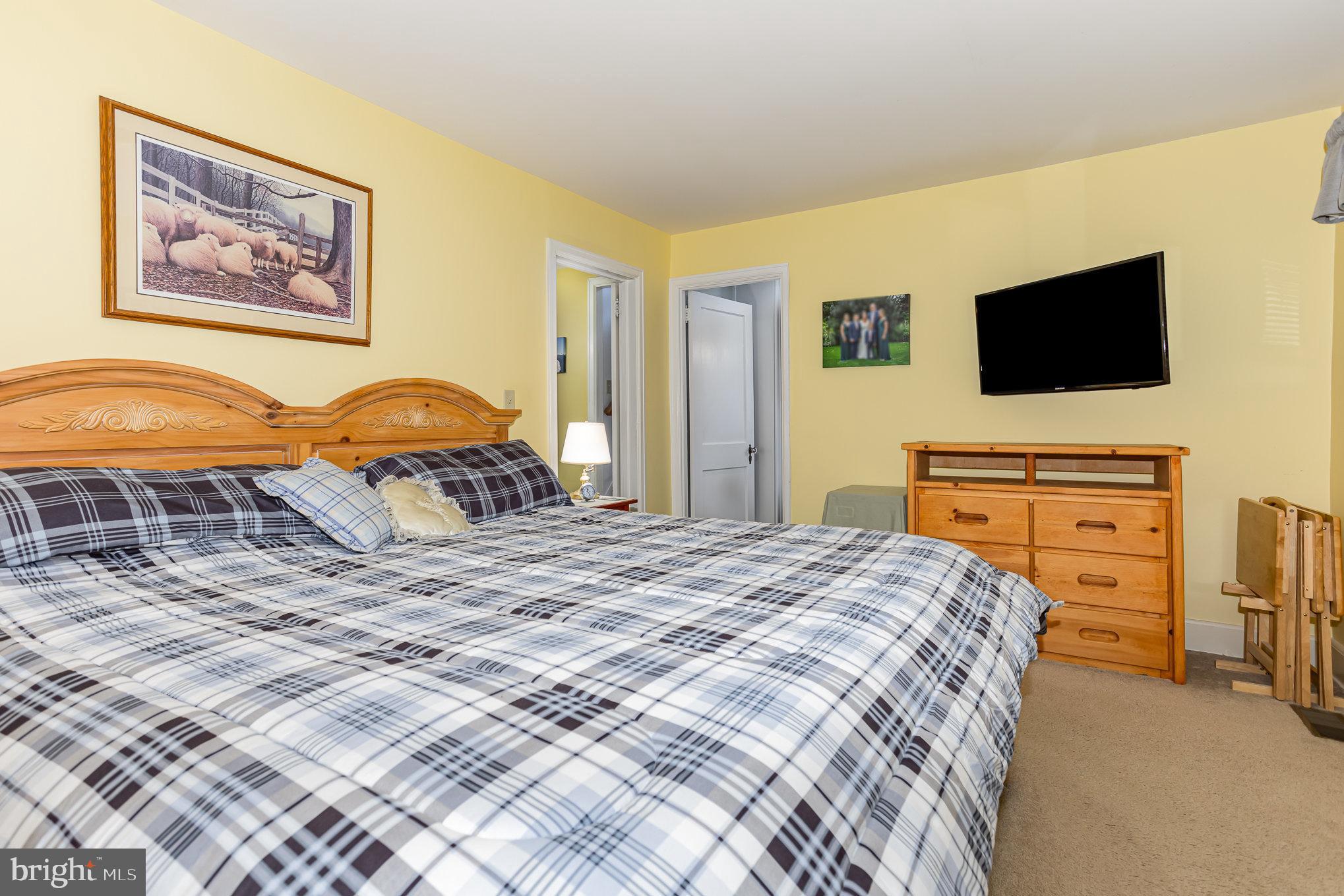 29 Maple Avenue Hershey, PA 17033 - Photo 15 of 32 a bedroom with a bed and flat screen tv