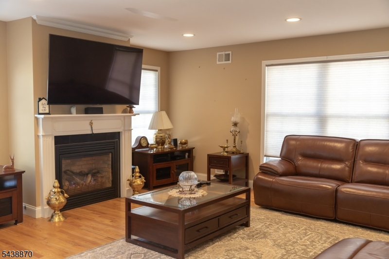 419 Putnam Road Union, NJ 07083 - Photo 16 of 37 a living room with furniture a flat screen tv and a fireplace