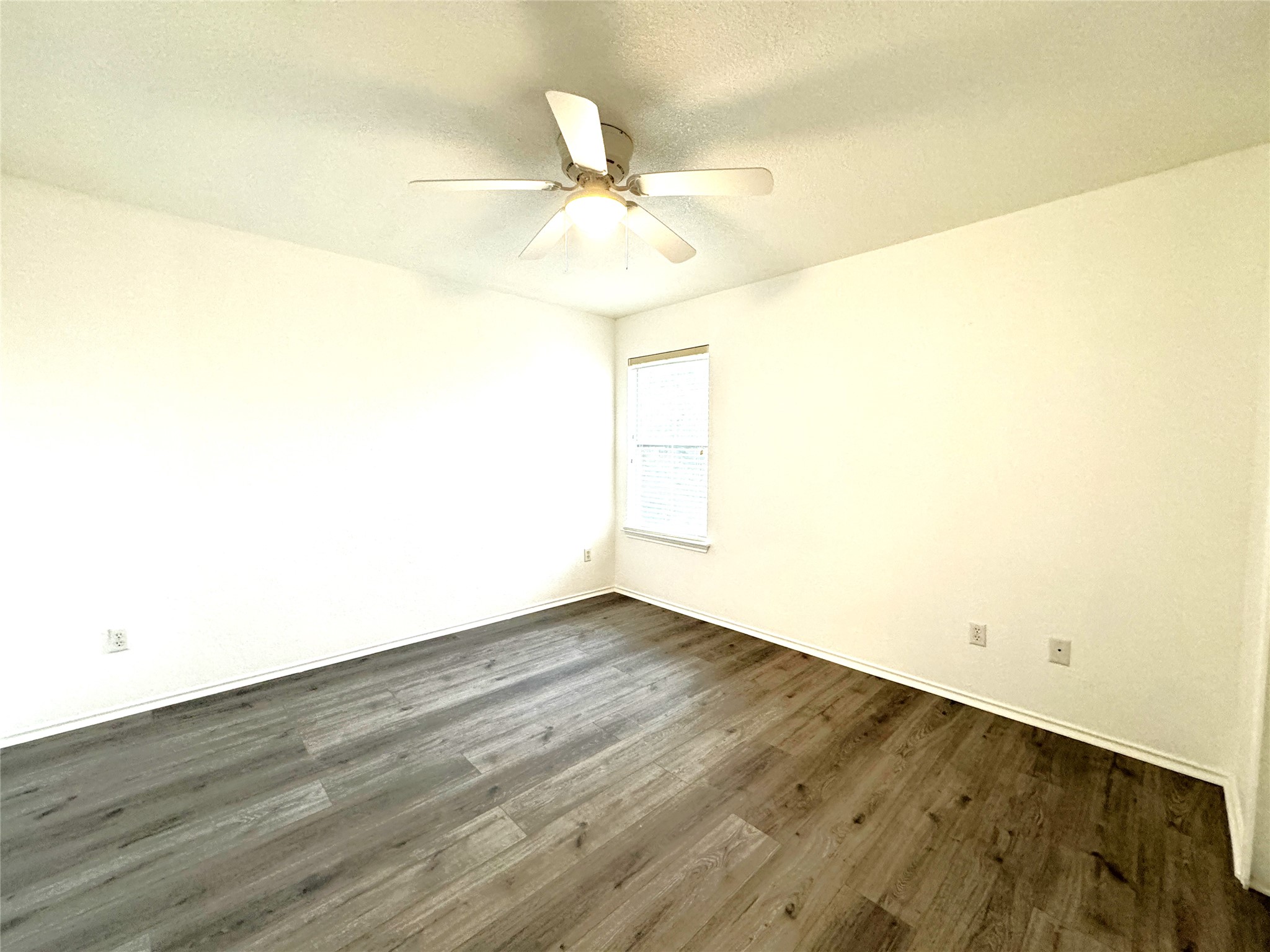 115 Killian Loop Hutto, TX 78634 - Photo 8 of 14 A quiet bedroom showcases durable wood flooring and a refreshing ceiling fan.