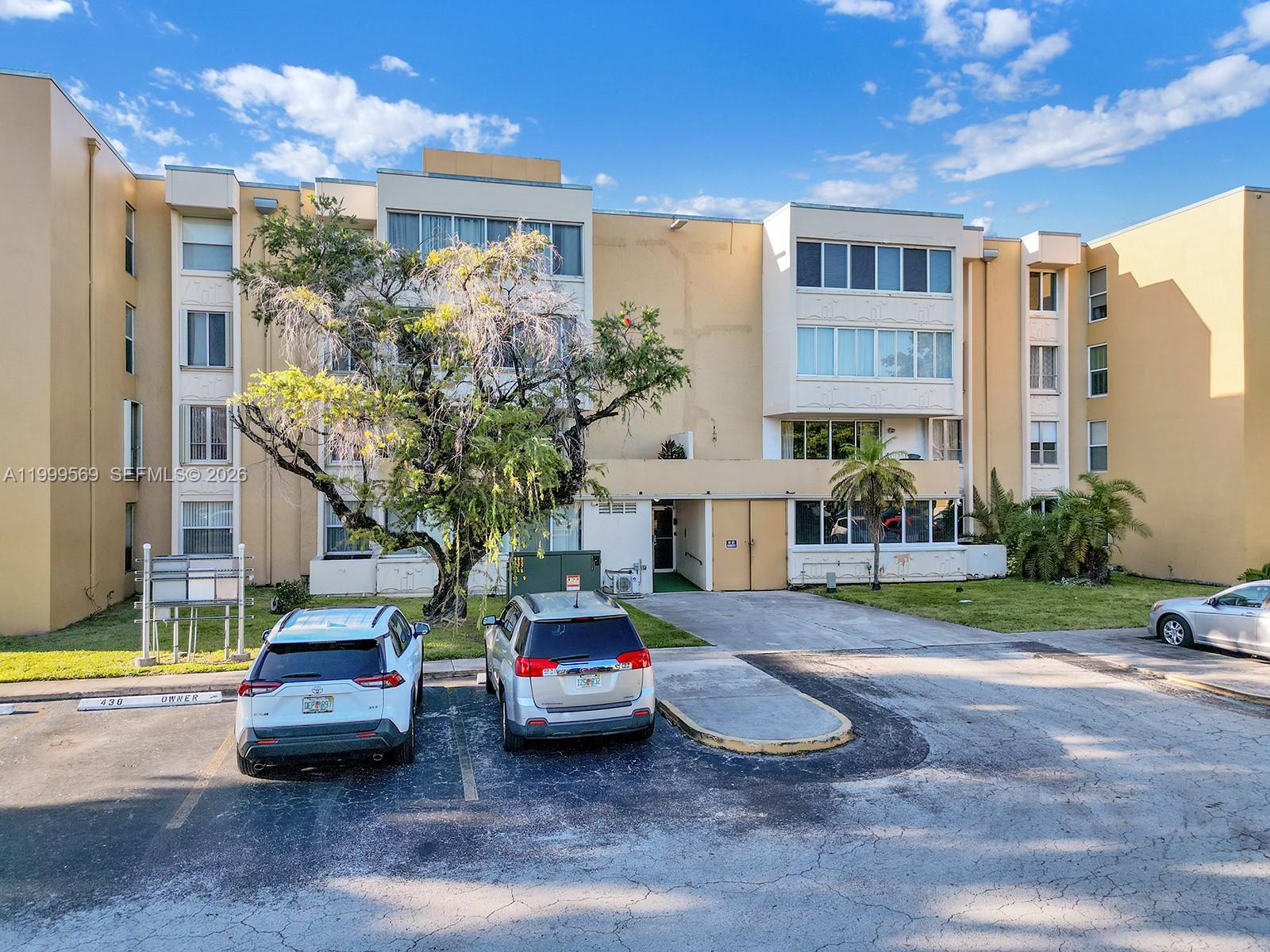 6841 Southwest 147th Avenue, Unit 2H Miami, FL 33193 - Photo 1 of 22 a car parked in front of a house