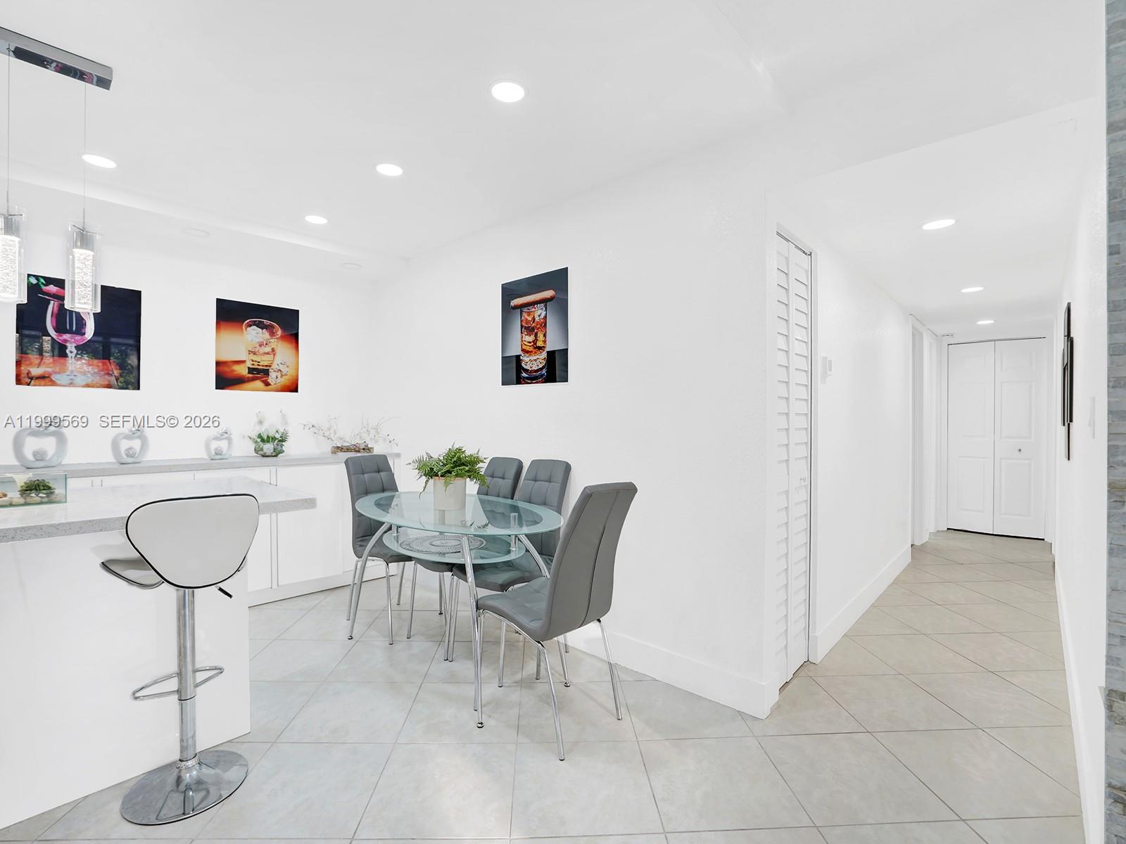 6841 Southwest 147th Avenue, Unit 2H Miami, FL 33193 - Photo 14 of 22 a view of a dining room with furniture