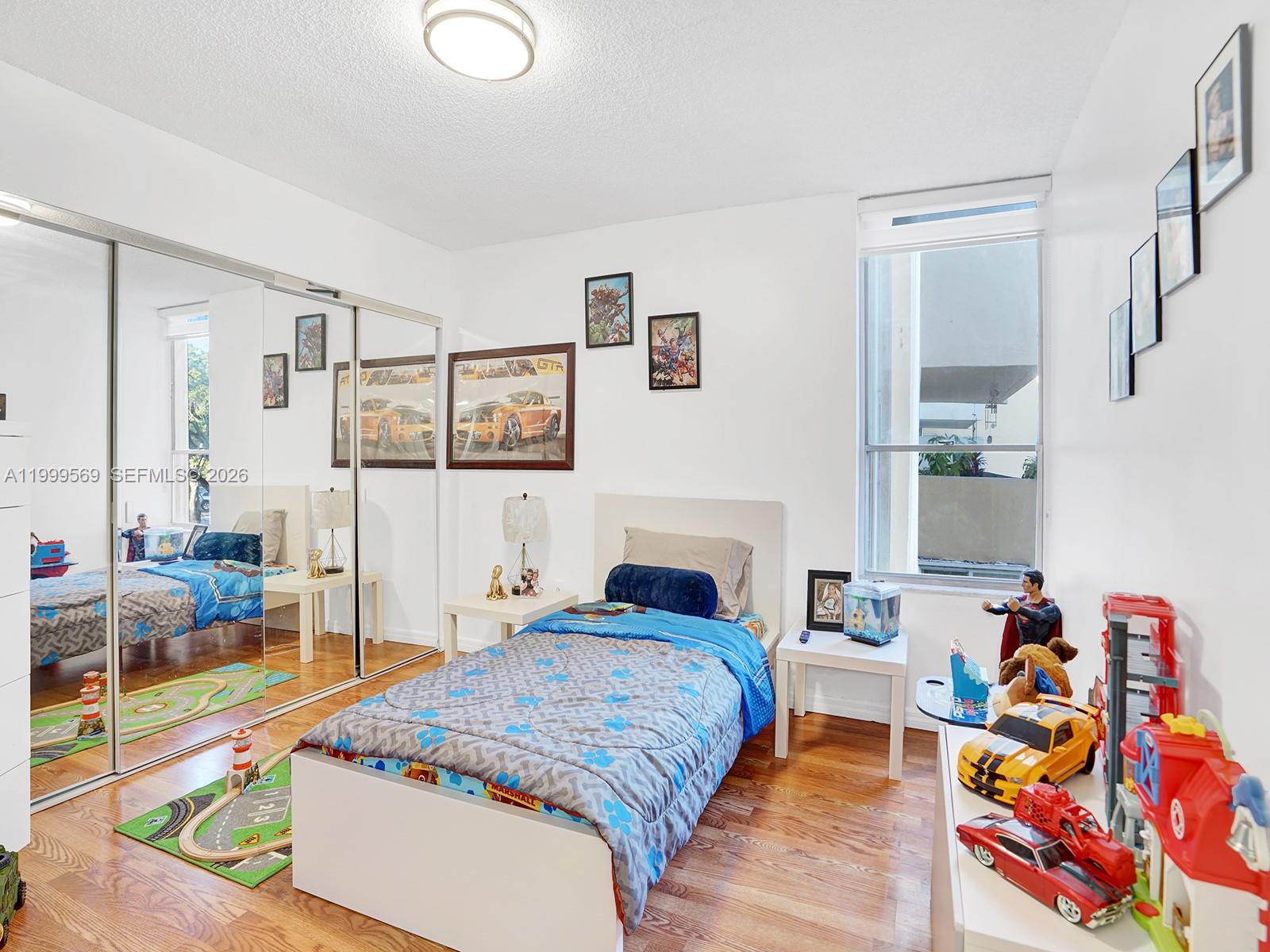 6841 Southwest 147th Avenue, Unit 2H Miami, FL 33193 - Photo 15 of 22 a bedroom with a bed and a couch