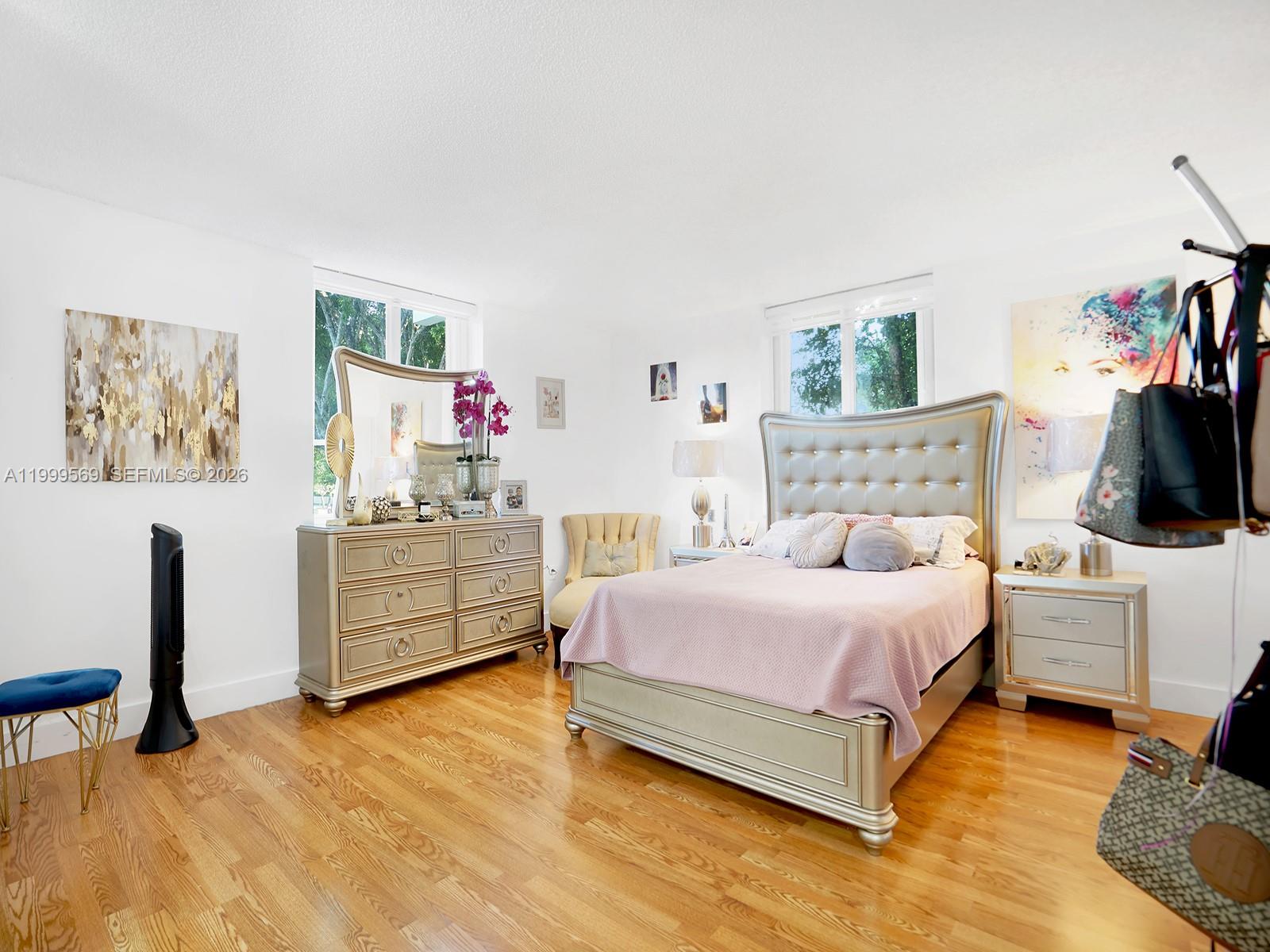 6841 Southwest 147th Avenue, Unit 2H Miami, FL 33193 - Photo 17 of 22 a bedroom with a bed and a flat screen tv