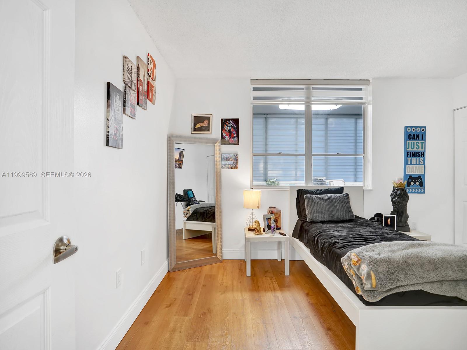 6841 Southwest 147th Avenue, Unit 2H Miami, FL 33193 - Photo 21 of 22 a bedroom with a bed and a table