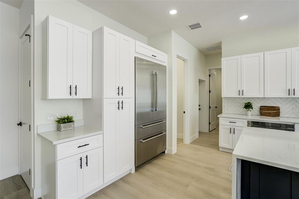 319 Cedar Lane Largo, FL 33770 - Photo 12 of 37 a kitchen with white cabinets and stainless steel appliances