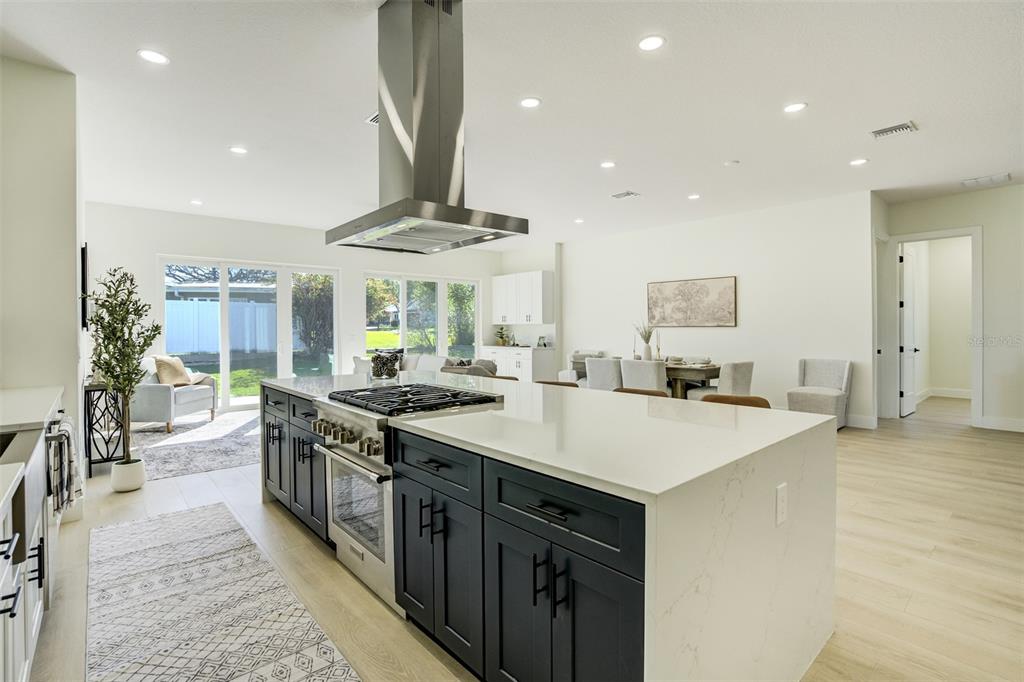 319 Cedar Lane Largo, FL 33770 - Photo 13 of 37 a kitchen with stainless steel appliances a sink stove and table