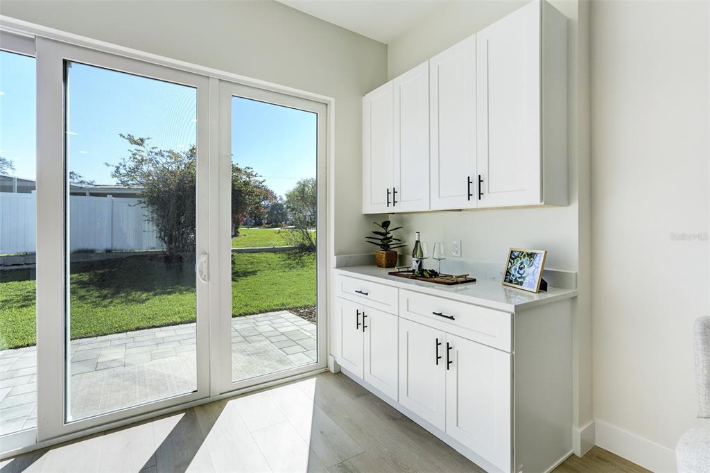 319 Cedar Lane Largo, FL 33770 - Photo 16 of 37 a kitchen with a refrigerator a stove and white cabinets